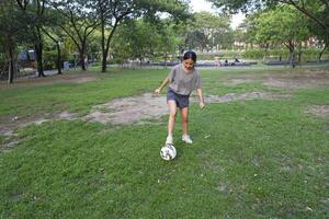 female soccer players practice using the ball in the park field diligently and happily. photo