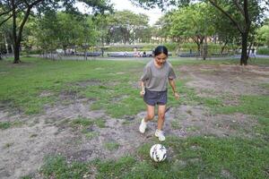 female soccer players practice using the ball in the park field diligently and happily. photo