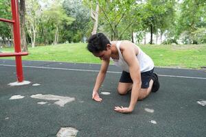 Asian man practicing gymnastics doing gymnastics bar and hoop exercises and stretching and resting for sports. photo