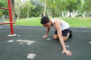 Asian man practicing gymnastics doing gymnastics bar and hoop exercises and stretching and resting for sports. photo