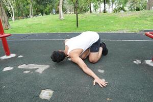 Asian man practicing gymnastics doing gymnastics bar and hoop exercises and stretching and resting for sports. photo