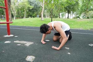 Asian man practicing gymnastics doing gymnastics bar and hoop exercises and stretching and resting for sports. photo