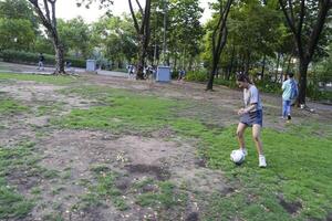 female soccer players practice using the ball in the park field diligently and happily. photo