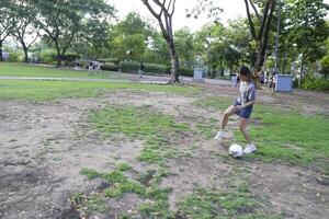 female soccer players practice using the ball in the park field diligently and happily. photo