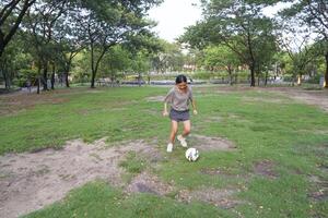 female soccer players practice using the ball in the park field diligently and happily. photo