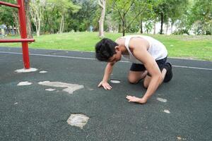 Asian man practicing gymnastics doing gymnastics bar and hoop exercises and stretching and resting for sports. photo