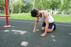 Asian man practicing gymnastics doing gymnastics bar and hoop exercises and stretching and resting for sports. photo