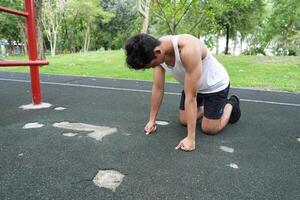 Asian man practicing gymnastics doing gymnastics bar and hoop exercises and stretching and resting for sports. photo