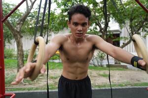 Asian men practicing swimming and polo and stretching and resting for water sports. photo