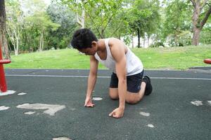 Asian man practicing gymnastics doing gymnastics bar and hoop exercises and stretching and resting for sports. photo