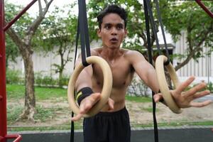 Asian men practicing swimming and polo and stretching and resting for water sports. photo