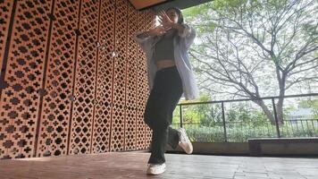 Asian girl dancing hip hop having fun With brightness and cheerfulness in the park area photo