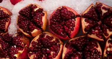 Pomegranate juice. Freshly squeezed pomegranate juice wave is flowing into a jug in slow motion video