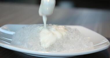 Prepare yogurt with ice Close up of twist white cream spining add more flour and mixing color in the blow video