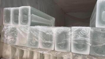 Close up of a worker loading small block of ice inside the trailer Deliver Ice to the store video
