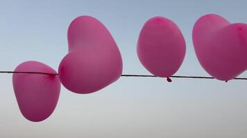red balloons in the shape of a heart on a light background. Valentine's Day. Heart ball video