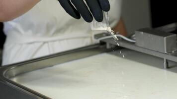 Mozzarella Caciocavalo Filling molds for the production of soft cheese. The cheese blanks are soaked in brine. Cheese factory preparing cheese video