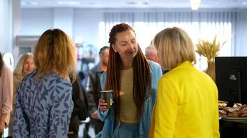 Alumni meeting Meeting of friends standing hugging talking new girls in yellow and blue clothes are coming up video