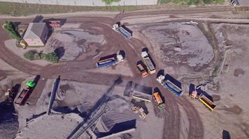 Excavator loading crushed stone into a dump truck in a crushed stone quarry video