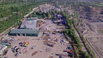Excavator loading crushed stone into a dump truck in a crushed stone quarry video