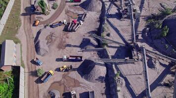 Excavator loading crushed stone into a dump truck in a crushed stone quarry video