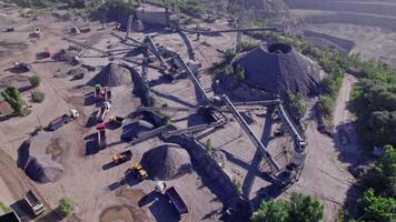 Excavator loading crushed stone into a dump truck in a crushed stone quarry video