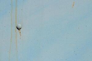 Weathered Rusty Rivet on Blue Painted Wall Texture photo