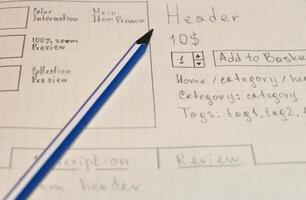 Online shop single page prototyping sketch with blue pencil. Web photo