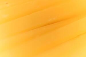 Solid cheese slices macro closeup. Background Texture. photo