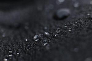 Water drops on black leather background texture. Macro Closeup. photo