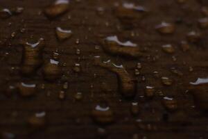 Rain water drops on wood board. Fresh background. Macro closeup. photo