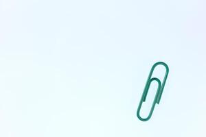 One Colored Isolated Paper Clips. Office Stationery Equipment Background. photo