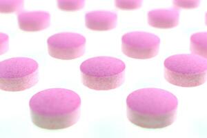 Pink Isolated Pills Texture. Medical Tablets Background. Macro Closeup. photo