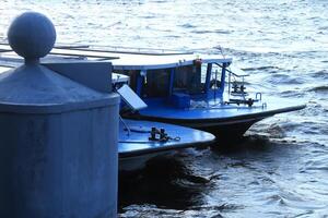 Noses moored passenger pleasure boats. Embankment of the Neva River. photo