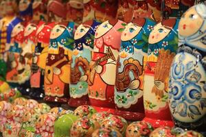 A lot of souvenirs of nesting dolls. Many colored nesting dolls. photo