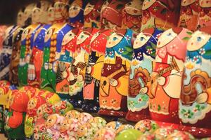 A lot of souvenirs of nesting dolls. Many colored nesting dolls. photo