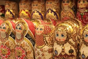 A lot of souvenirs of golden nesting dolls. Many colored golden nesting dolls. photo