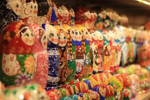 A lot of souvenirs of nesting dolls. Many colored nesting dolls. photo