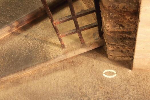 The symbol of zero at the open gate of the foot of a stone spiral staircase. photo