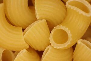Many Horns Pasta Texture. Traditional Noodles. Uncooked Macaroni Food Background. Macro Closeup. photo
