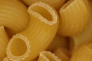 Horns Pasta Texture. Traditional Noodles. Uncooked Macaroni. Vegetarian Food Background. Macro Closeup. photo