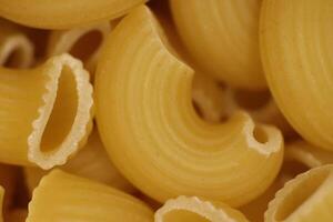Horns Pasta Texture. Uncooked Macaroni. Vegetarian Food Background. Macro Closeup. photo