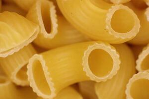 Italian Horns Pasta Texture. Uncooked Macaroni Food Background. Macro Closeup. photo