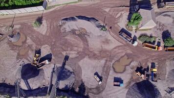 Excavator loading crushed stone into a dump truck in a crushed stone quarry video