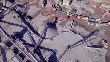 Excavator loading crushed stone into a dump truck in a crushed stone quarry video