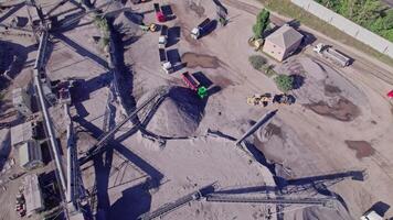 Excavator loading crushed stone into a dump truck in a crushed stone quarry video