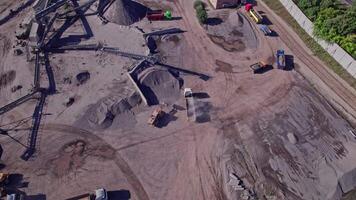 Excavator loading crushed stone into a dump truck in a crushed stone quarry video