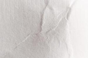Crumpled White Paper Texture with Soft Folds. Macro Closeup. photo