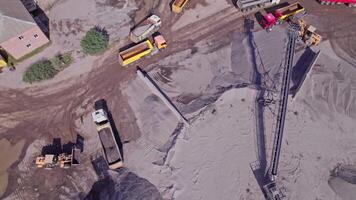 Excavator loading crushed stone into a dump truck in a crushed stone quarry video