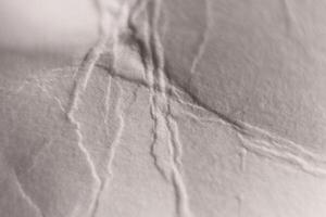 Soft Folds on Crumpled White Paper Texture. Macro Closeup. photo